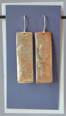Reticulated sterling silver fused to copper rectangles. 2 1/2" long x 9/16" wide with sterling silver earwires