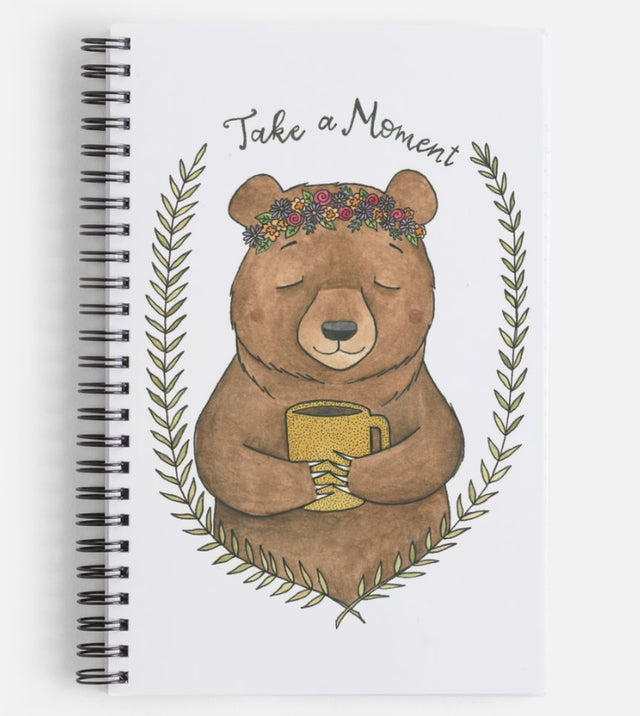  "Take A Moment" Bear Notebook Artist:  Tara Pappas  Brown bear holding a yellow coffee cup  Take A Moment and foliage around the bear  Laminated cover on the journal  Full color front cover, from the Artist's original artwork  Black and white back cover  Lined  8.5" x 5.5"  Great for inspired journaling