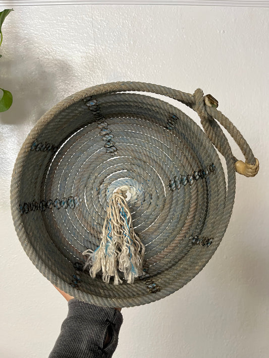 Blue Brimless Rope Basket Artist: Aleah Russell  Repurposed lariat rope  Rope came from an authentic Wyoming ranch  Basket with high, straight sides and tassel in center  Will add a touch of country to any home  Would make a nice fruit basket  Add a bowl inside for holding small items  11.5" long x 3" high x 10" wide
