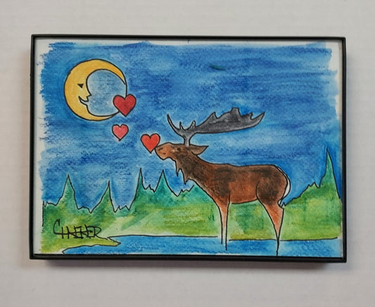 " Moose Loves Moon " Framed Original Watercolor and Ink Artist: Celeste Havener Original watercolor and ink drawing  Moose standing in the water looking up and sending hearts to the moon  Dark blue night sky with pine trees in the background  Framed in sleek black plastic frame  Can be hung on a wall or use the frames easel back to set on a table  Would make a great wedding or anniversary gift  7" long x 5" high x 1/2" deep