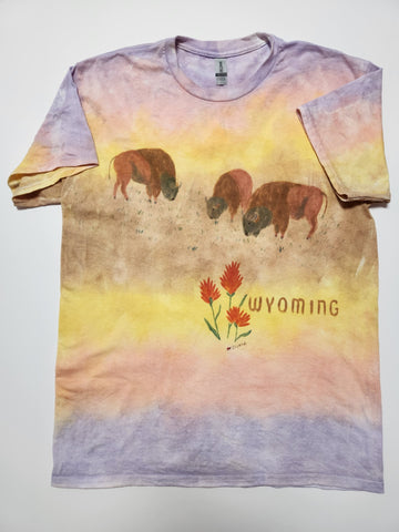 hand dyed t-shirt with 3 bison and Indian Paintbrush flowers handpainted on the shirt. Wyoming hand written next to the paintbrush