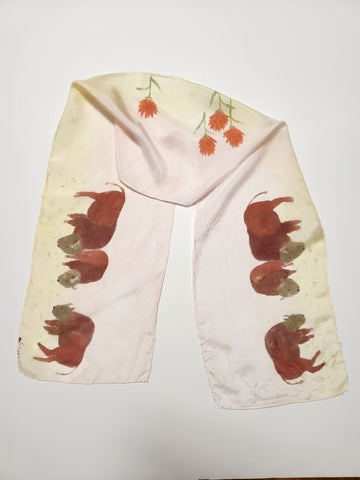 8" x 54" silk scarf. hand dyed in light pink and light yellow colors.   3 bison hand painted on each end. Indian paintbrush flowers hand painted in the center