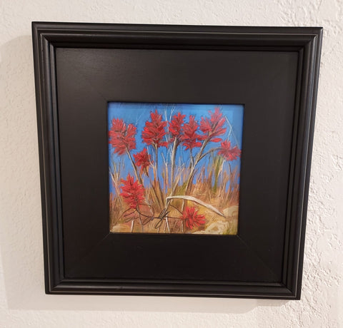 pastel painting of Indian Paintbrush flowers. In a black frame