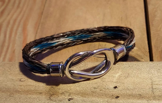hand braided horsehair bracelet in brown with dyed teal, blue and gray dyed hair. Magnetic infinity knot clasp
