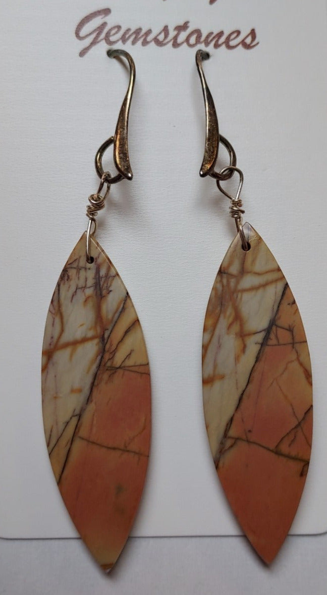 Cherry Creek Jasper Pointy Ovals with Silver Earrings Artist: Tom Gaddis  Cherry Creek Jasper cut into pointed oval shapes   Light brown and orange colored   2 1/2" long x 1/2" wide at the widest point   Sterling silver ear wires   These earrings would go well with many different outfits