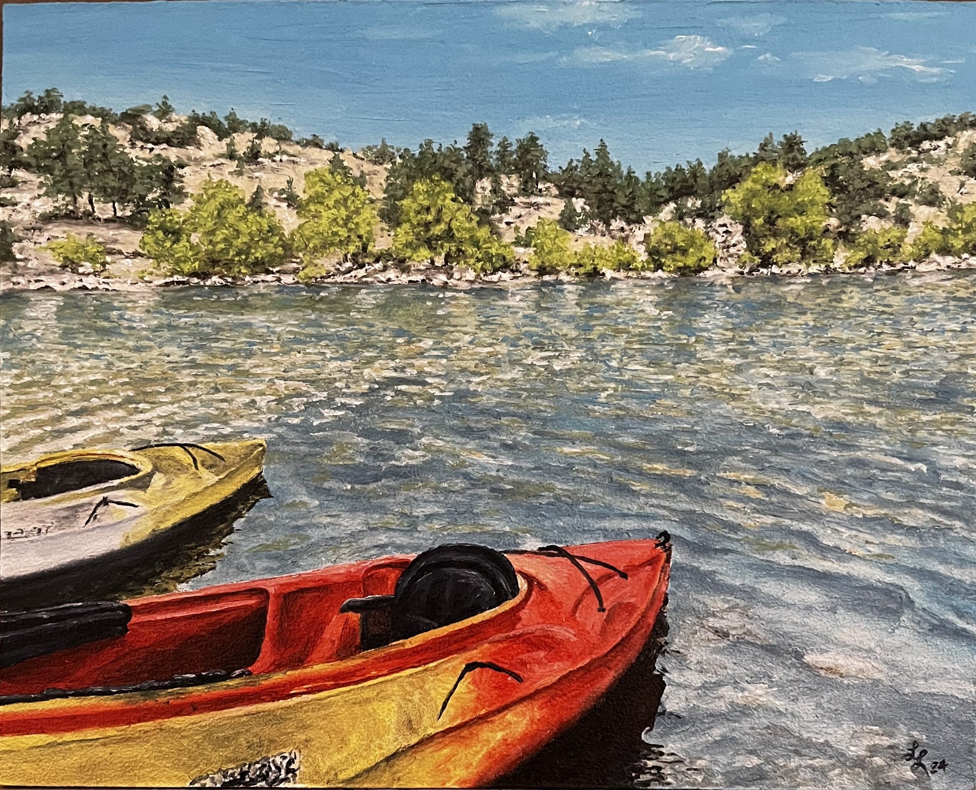 Red and yellow kayaks in a lake. trees along the shoreline. blue sky with just a hint of clouds in the sky