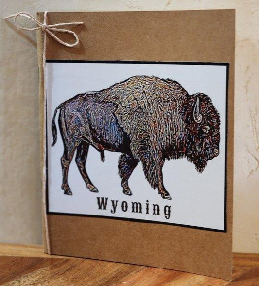Small pocket notebook with print of original artwork by the artist Colorful Bison affixed to the cover of the notebook