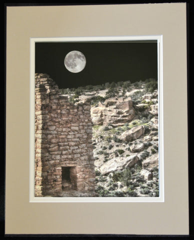 Matted color photograph of the Hovenweep House in the Hovenweep National Monument in Utah  Full moon stands bright in the night sky above the rock house  Tan and cream colored matting around the print  8" long x 10" high print  11" long x 14" high as matted  In a plastic sleeve and on sturdy foam board for added protection  Ready for a frame or to be displayed on an easel