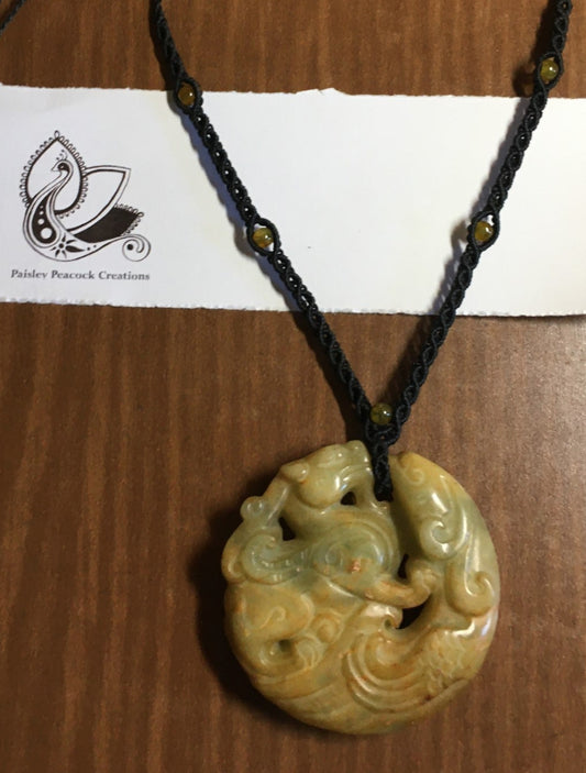 carved jade pendant on a hand knotted macrame necklace