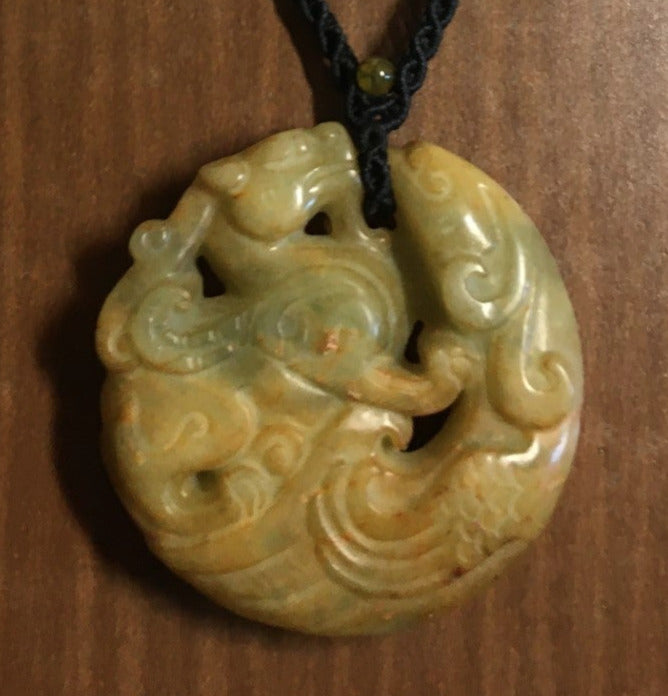 intertwined fish and dragon jade pendant