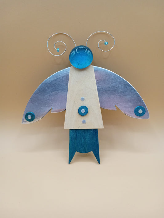 Blue wood body with metal coated wings  Metal wire antennae  Blue glass bead head. Blue wood body with metal coated wings  Metal wire antennae  Blue glass bead head  7" long x  7" wide x  1/2" high  Wonderful year around decoration  Great for any insect enthusiast  Wire hanger on back