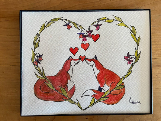 Original watercolor and ink drawing  Two red fox sitting nose to nose  Hearts floating between and above them  Fuchia wreath in the shape of a heart surrounds the two fox  Framed in sleek black plastic frame  Can be hung on a wall or use the frames easel back to set on a table