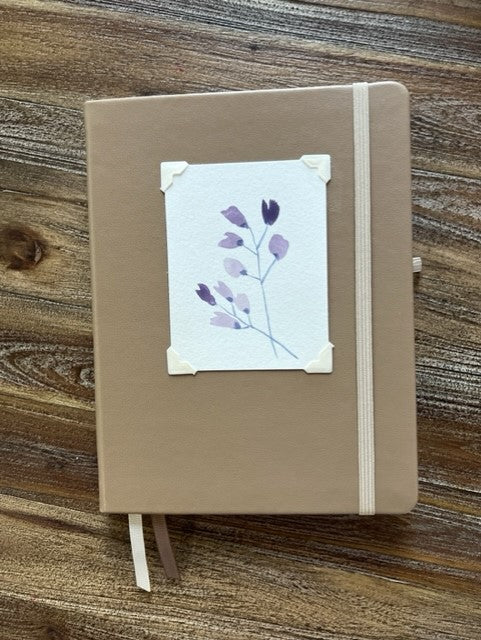 Taupe cover  Dot / bullet journal pages  Original watercolor painting of purple flowers attached to the cover  Taupe elastic strap to hold book secure  Ribbon to mark you pages  Take with you anywhere you go  6" long x 8" high x 3/4" wide