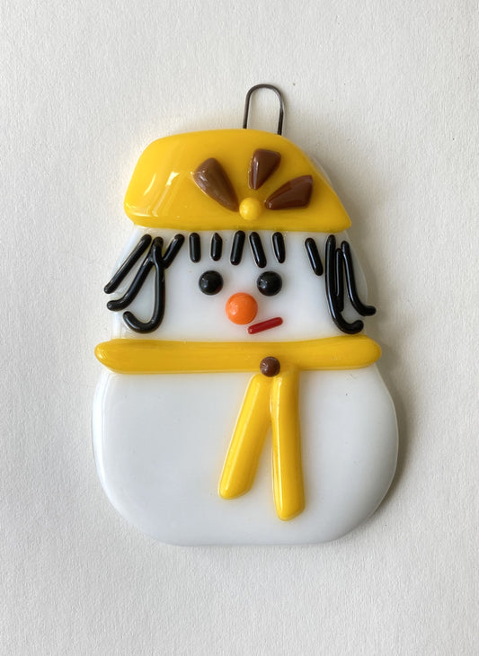 fused glass ornament. girl snowman with black hair in yellow hat and scarf. Unviersity of Wyoming football fan