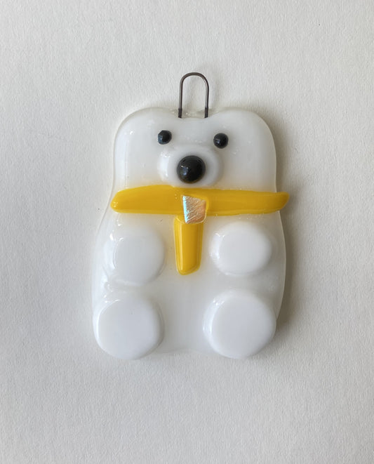 fused glass polar bear wearing a yellow scarf with jewel