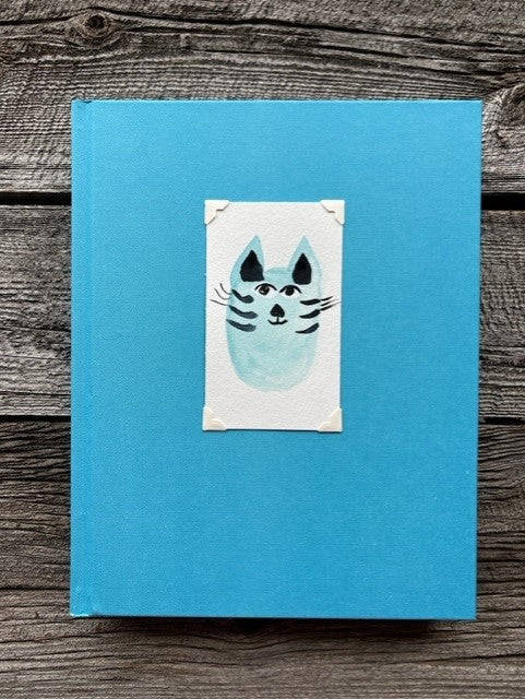 Hardcover light blue sketchbook  Original watercolor of a blue kitty cat attached to the cover  Blank pages for sketching  Perfect for artists or anyone who likes to sketch  9" long x 11" high x 1 1/4" wide