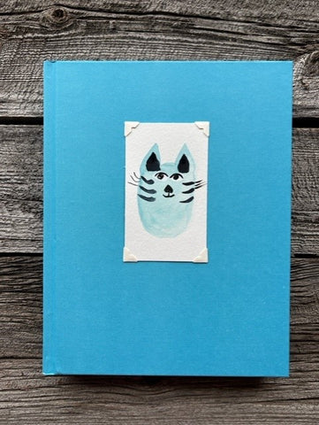 Hardcover light blue sketchbook  Original watercolor of a blue kitty cat attached to the cover  Blank pages for sketching  Perfect for artists or anyone who likes to sketch  9" long x 11" high x 1 1/4" wide