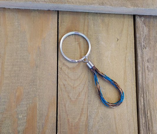 Keychain with a braided design on a wooden surface