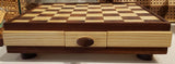 Heirloom quality checker board from Sapele and Ash hard woords. Handcrafted. Sapele edge with ash trim. Included 12 each of light or dark checkers. Flip over with the two colors for a King. Red felted feet add elegance to this game board. Sure to be a family facorite.