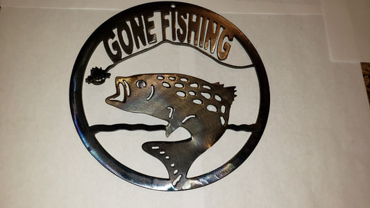 " Gone Fishing " Small Metal Sign Artist: Michael McMahon Grinded and heat tinted metal  Clear coat protective enamel  3D fish jumping out of water to catch a fly on a hook and line  7 1/4" diameter  Fish and fly are bent out 1"  Please note items are hand made by artist and there will be a slight variation between each piece