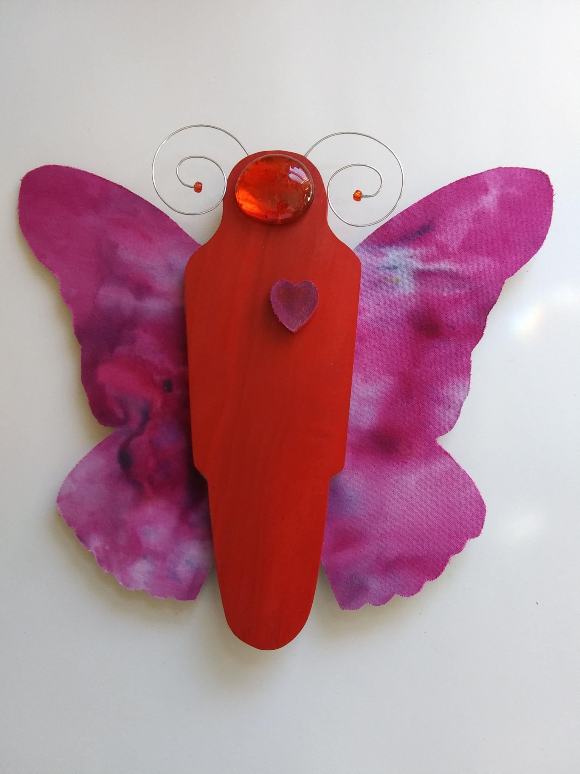 "Butterfly" Red Tye Dye Butterfly Hanging Stained Glass Artist: Bruce Allemani  Red body of the butterfly with Tye dye wings  8 1/2" long x  8" wide x  1/2"  Would look great hanging in a living room or a window  Please note, each piece is custom designed by the Artist , with a slight variation between each piece