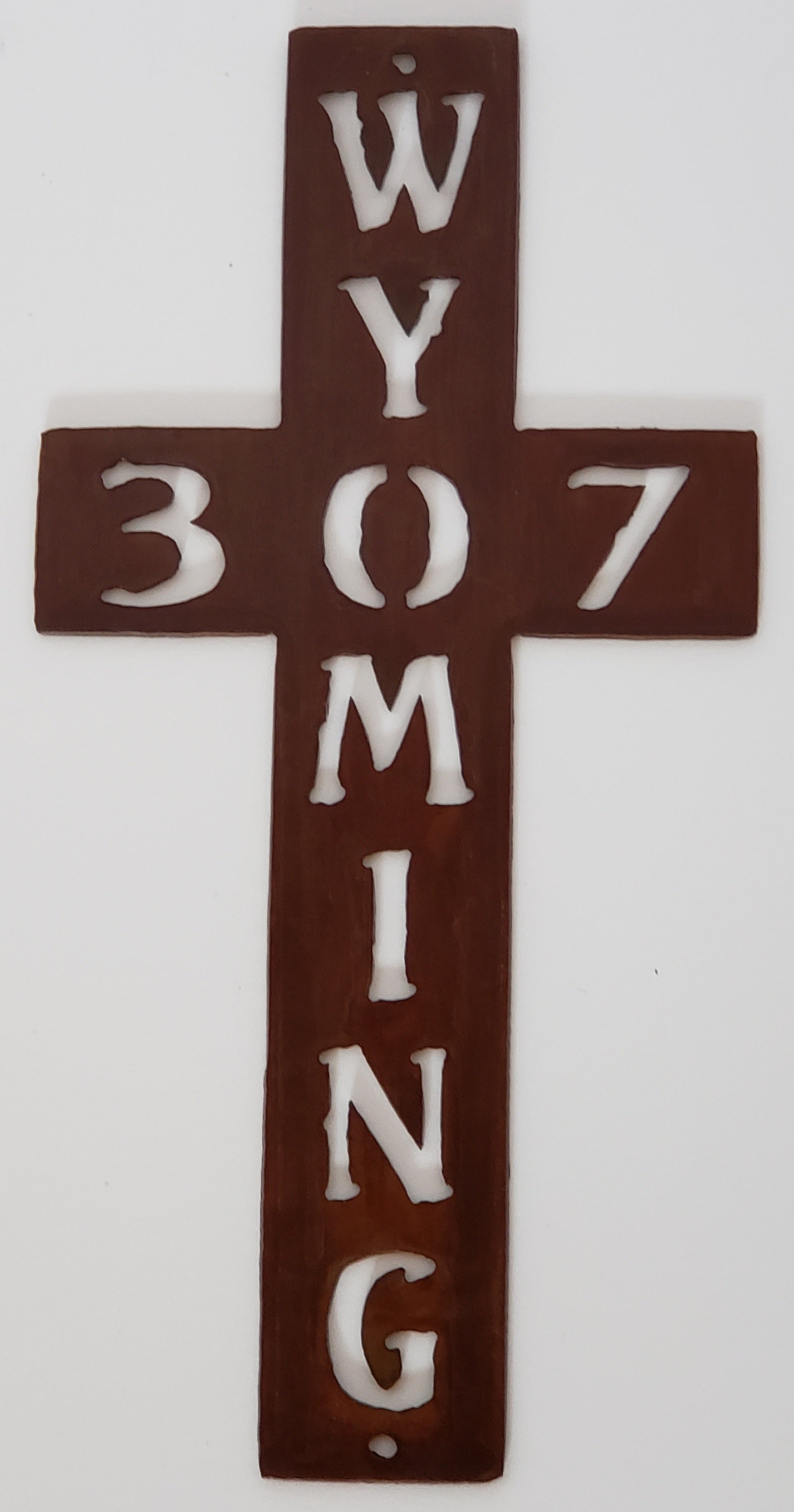 small metal cross.  Wyoming going down the cross and 307 across. wall hanging