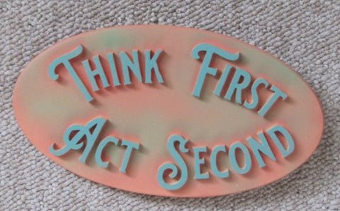 coral colored oval sign. think first act second