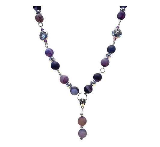 Purple Droozy Agate Necklace And Earring Set Artist: Casey Hanson Purple Droozy Agate beaded necklace with silver accents  Silver lotus beads  Matching earrings with silver ear wires  Necklace is 26" long  Earrings measure 1 1/2" long