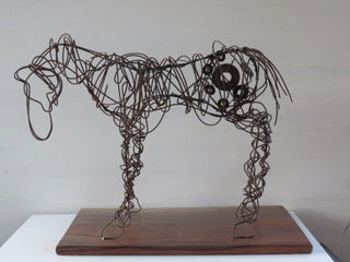 " Palouse " Wire Horse Sculpture Artist: Celeste Havener Wire Horse Sculpture  Baling wire bent and sculpted by hand into a wire horse statue  Small pieces of found hardware woven into the sculpture  Base made from Walnut that has been sanded  19" long x 9" wide x 13" high