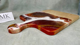  There is a little extra care with this board.  Be sure to hand wash and condition with a food-safe wood conditioning wax or oil occasionally to maintain the vivid finish.  Wipe the resin artwork with a microfiber cloth to maintain the glass-like sheen after hand washing with a mild soap and soft cloth. 