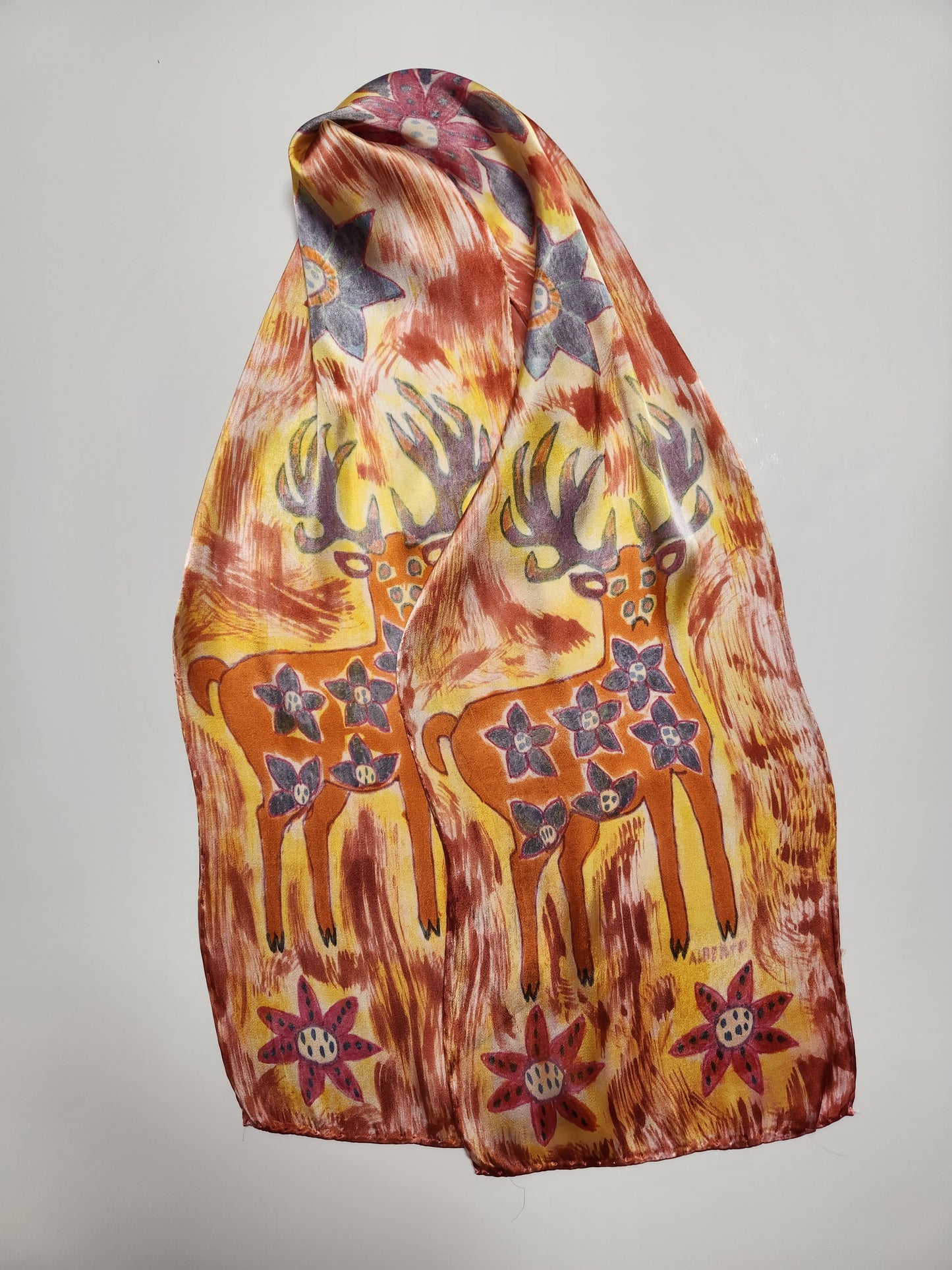 " Deer" Peruvian Art Rayon Silk Scarf Artist: Alberto Alcantara  11" x 58" silk scarf  Hand painted and hand dyed  Orange, purple, golds  Wyoming Deer  Bright  colored flowers  Wonderful scarf for completing a fun outfit