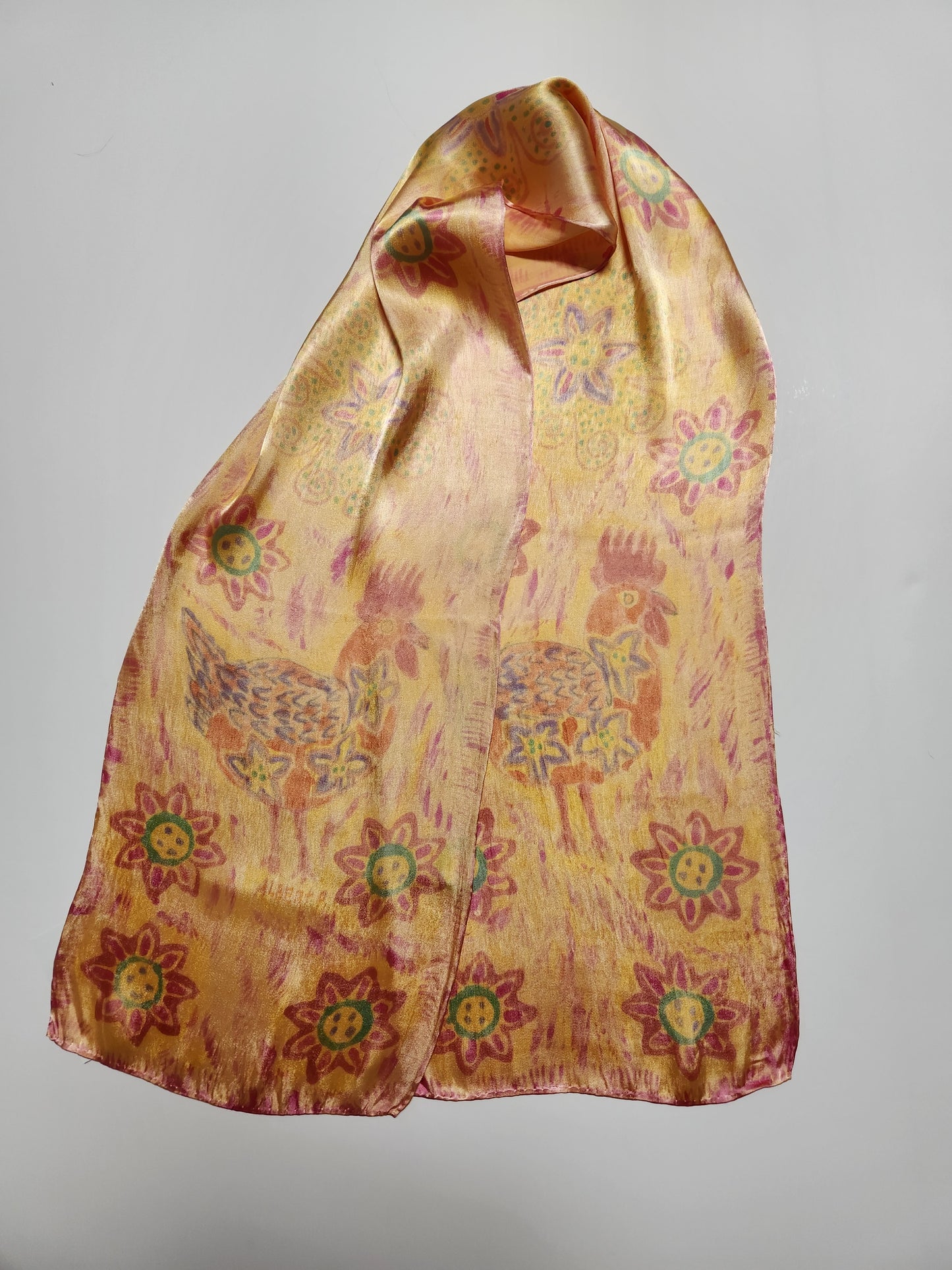 " Rooster " Peruvian Art Rayon Silk Scarf  Artist: Alberto Alcantara  11" x 58" silk scarf  Hand painted and hand dyed  Orange, purple, pink, yellow  Rooster design  Bright multi colored flowers and suns  Wonderful scarf for completing a fun ou