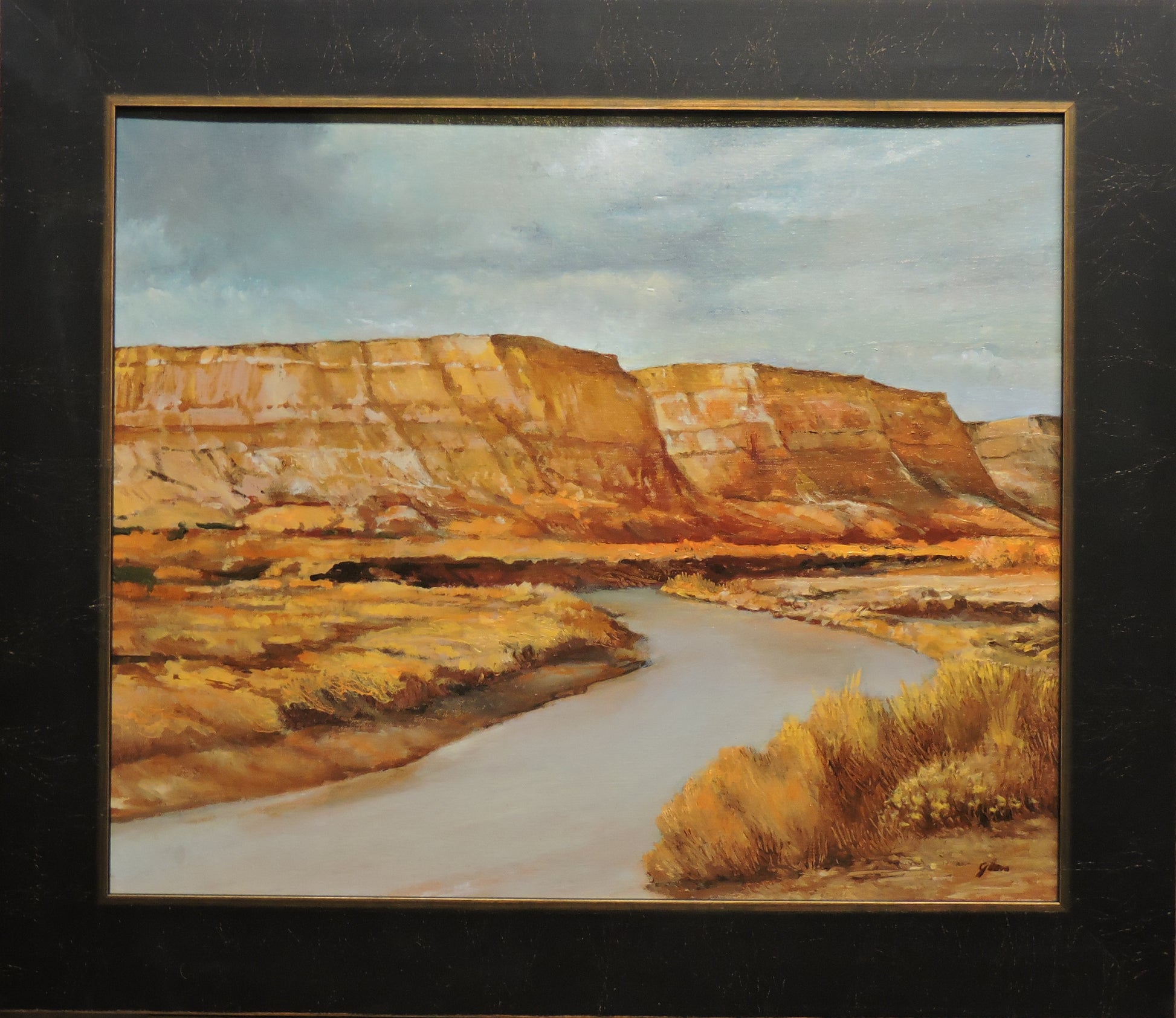 " A Bend In The River " Original Oil Painting Artist: Jerry Glass Original Oil Painting  Desert scene of a river and cliff  Looks like it could be from a river in Wyoming  Framed in a dark wooden frame with golden colored edges  Wire on the back for hanging  17 1/2" long x 14 1/2" high painting  22" long x 19" high x 3/4" wide as framed