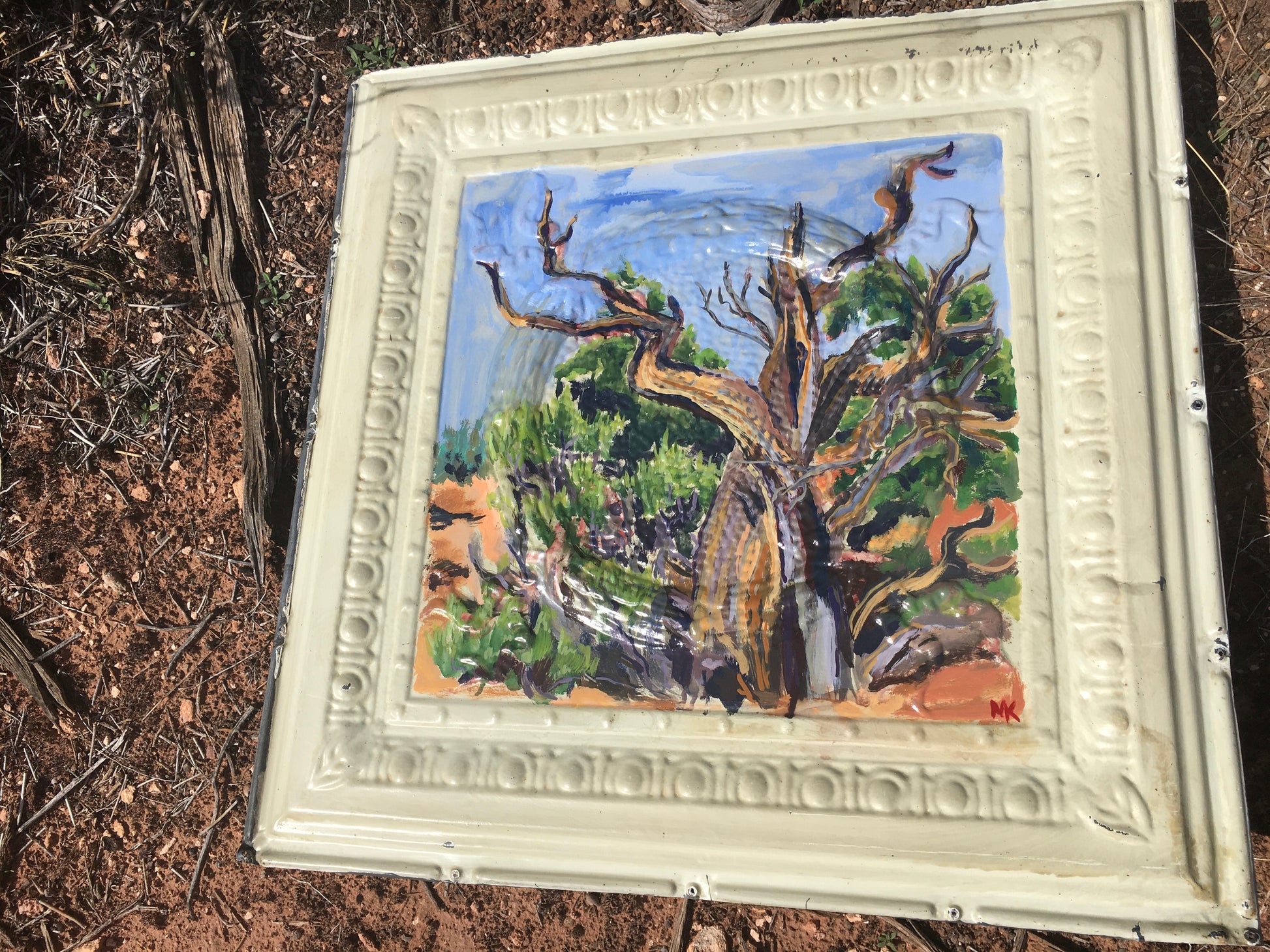 A close up view of the juniper tree and the detail of the antique metal ceiling tile