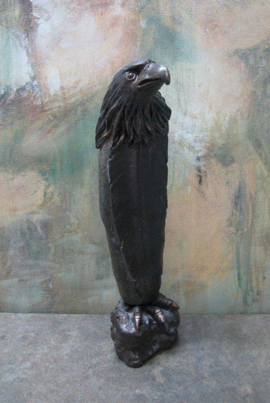 " Hunter " Stone And Bronze Sculpture Artist: Catherine Holt  Wyoming found stone  Cold cast Bronze eagle and feather   Sculpture measures 2" long x 7.5" high x 2.5" wide  Stone appears to have been a tool used by natives  Stone attached to a bronze base that looks like a rock