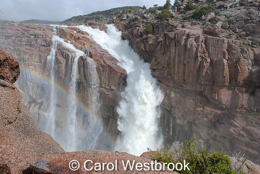 Wyoming's Pathfinder Resevoir Dam spill with rainbow in the mist.