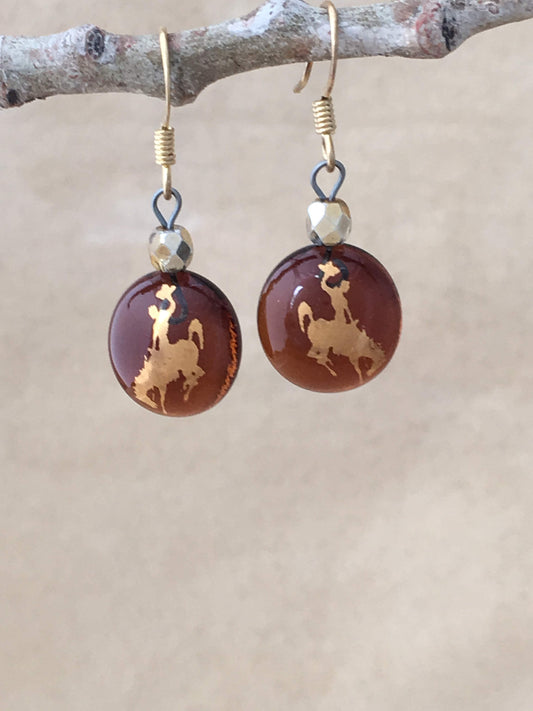 University of Wyoming Cowboy Round Dangle Earrings of rootbeer colored fused glass, 22kt gold foil bucking bronco and rider, ear wires