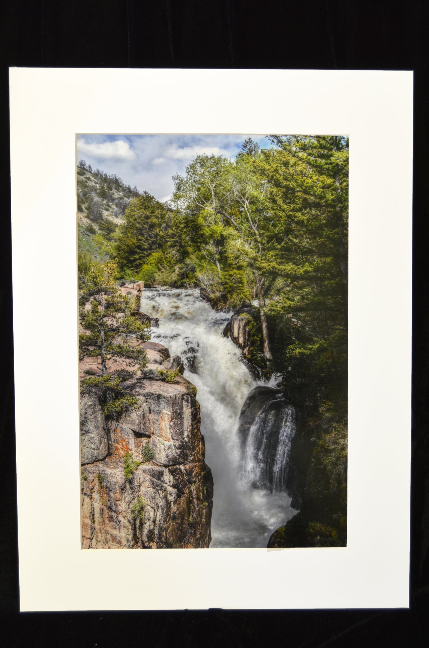 " Shell Falls " Matted Luster Print Photographer: Rowena Trapp Shell Falls Luster Matted Print                            The image was taken of Shell Falls   Bighorn Mountains of Wyoming during spring runoff  16.75" long x 10.75" wide luster print  2.5" wide white matting around the print  22" long x 16" wide in total  The mount board is thin containing acid free paperside of plastic sleeve for protection  Ready for a frame or to be displayed on an easel