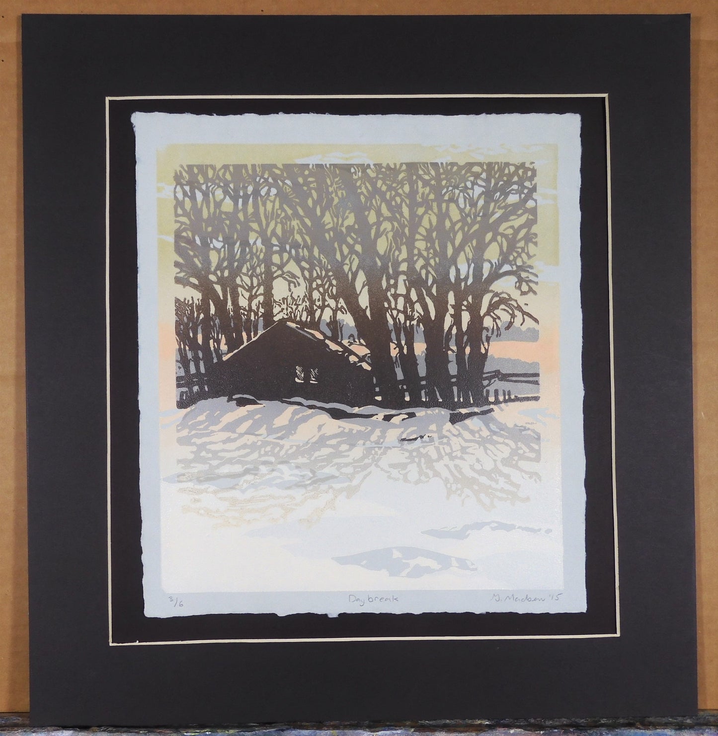 " Day Break " Matted Original Relief Print Artist: Ginnie Madsen  Cabin in the snow during day break  Printed on handmade paper  1 3/4" dark brown matting around the relief print  9" long x 11" high print on paper  14" long  x 15" high x 1/16" as matted  Ready for a frame  Original Relief print  Print # 3 o