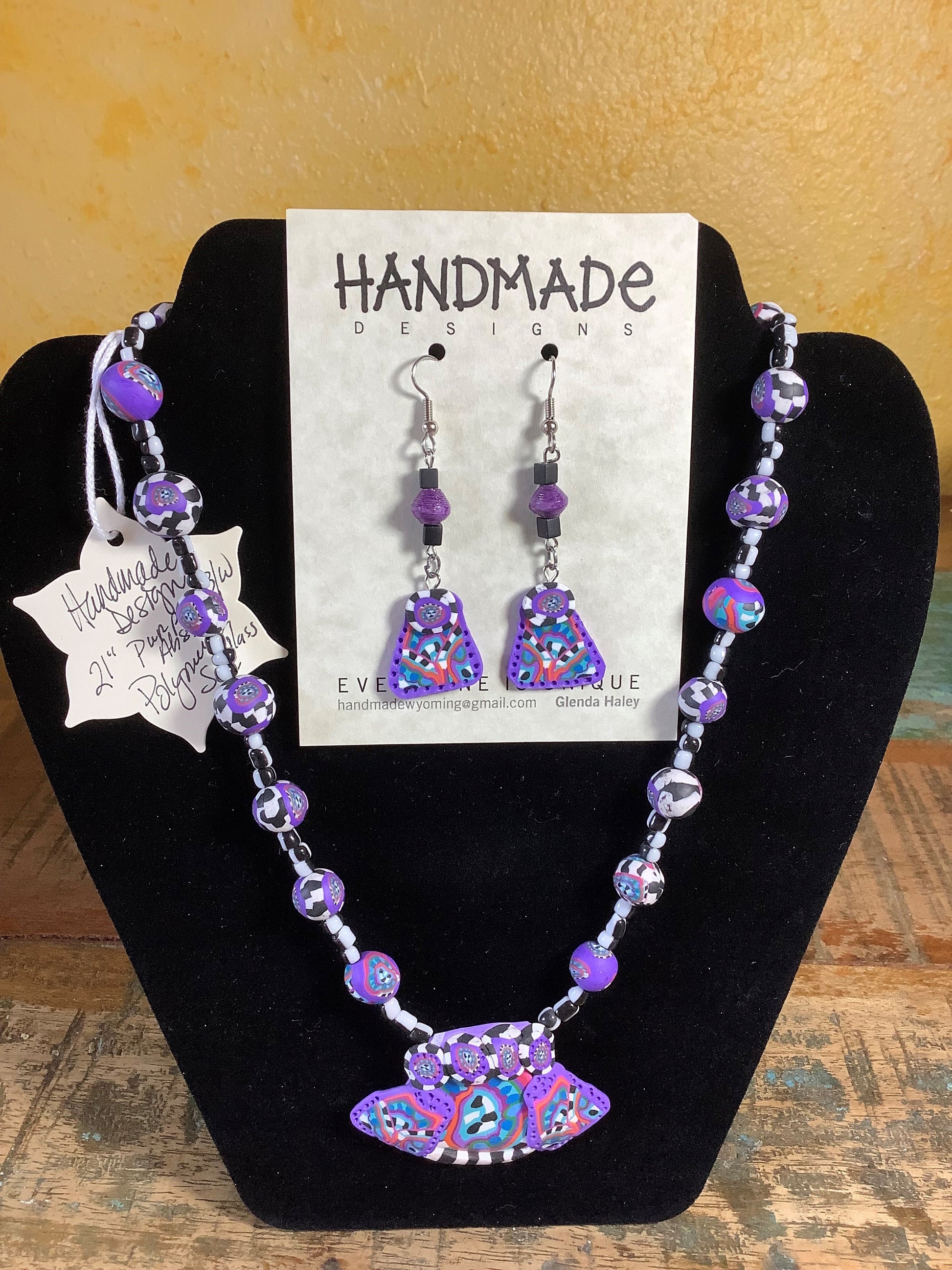 Variety Mixed Colors Polymer Clay Necklace and Earring Set Artist: Glenda Haley  Original, handcrafted Necklaces with matching Earrings  Created from Polymer Clay in Yellow, Orange and Purple swirls  The Earrings are drop beads from matching clay  Polymer Can Techniques  Purple, black and white Beads are hand made. Necklace is 21"  Glass accent beads