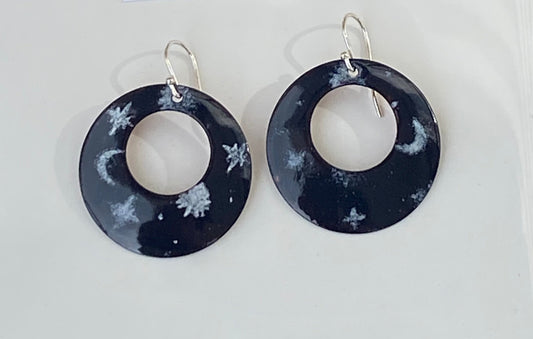 White Stars With Blue Enamel Hoop Earrings Jewelry Artist: Kristie Brown White stars pattern on a dark blue enamel background  Hoop shape enamel earrings  1 1/2" across  Sterling Silver ear wires