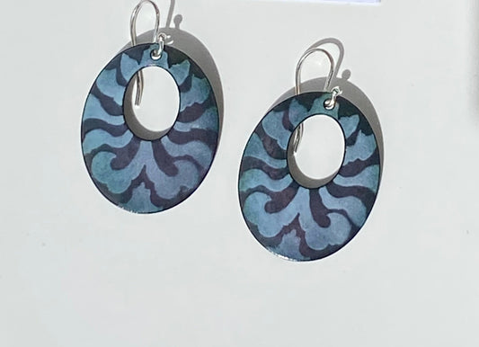 Oval Hoop Zebra Pattern Enamel Earrings Jewelry Artist: Kristie Brown Black and gray Zebra pattern enamel earrings  Oval Hoop shaped Earrings  1 1/2" long x  1" wide  Sterling Silver ear wires  Please note, each piece is custom designed by the Artist , with a slight variation between each piece   