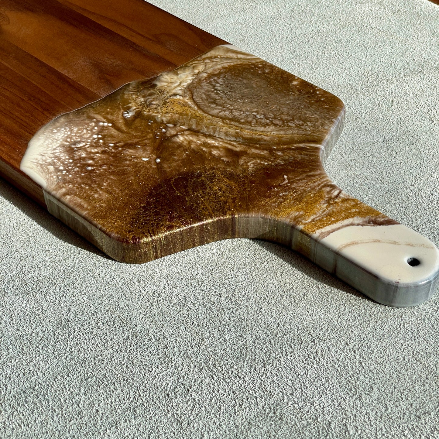 Artisan Walnut Charcuterie Cheese Board Artist: Marcy Knotwell  Brown, ivory and liquid gold resin designs  "You will not be disappointed with the quality of this product! Our handcrafted wood-grain edge charcuterie cheese boards are the answer to stylish, multi-functional, sustainable serve-ware.  When not in use, this charcuterie cheese board makes a beautiful addition to your countertop or gallery wall.