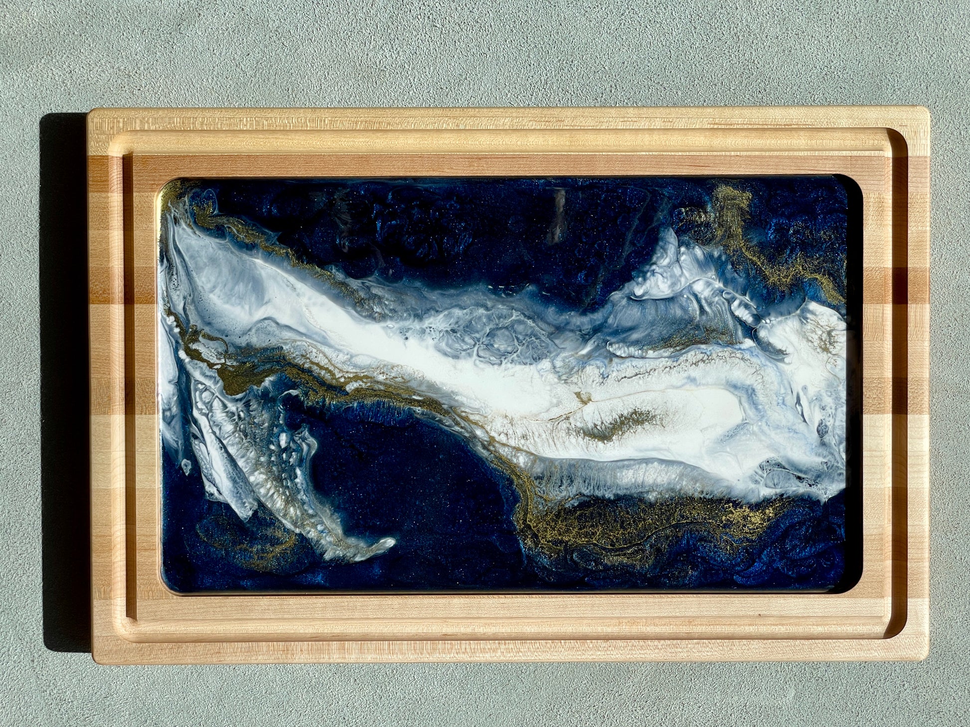 Impressive Artisan Resin / Wood Charcuterie Cheese Platter / Juice Artist: Marcy Knotwell Blue, white with liquid gold lacing resin designs Made from stunning maple wood, the natural hardness and unique resin color sets this charcuterie cheese board apart from any other. The artistic tone and delicate highlights brings this original piece of art front and center as a stylish, multi-functional, sustainable serving piece.