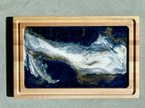 Impressive Artisan Resin / Wood Charcuterie Cheese Platter / Juice Artist: Marcy Knotwell Blue, white with liquid gold lacing resin designs Made from stunning maple wood, the natural hardness and unique resin color sets this charcuterie cheese board apart from any other. The artistic tone and delicate highlights brings this original piece of art front and center as a stylish, multi-functional, sustainable serving piece.