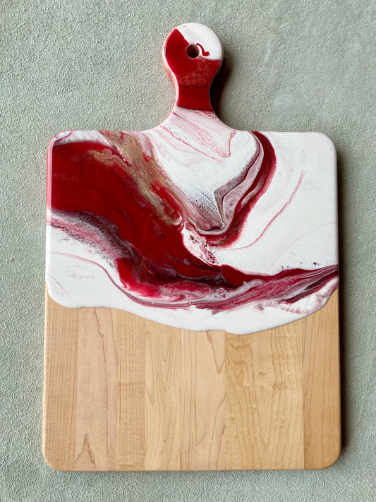 Red, white and gold resin on a maple wood cheese or charcuterie board