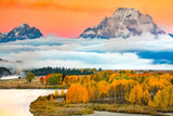 Mt Moran, Teton National Park on canvas. Low cloud banks hanging low in the meadows with the majestic mountain peaks rising above the cloud cover. Fall Colors  are in full splendor along the Oxbow river bank