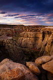  " Adobe Town Sunset " Lustre Print Photographer: Kyle Spradley  11"  x 14"  Lustre Print  Sunset amongst the moon-like formations of Adobe Town  Red Desert of Southern Wyoming  Very unique formation in the walls and a deep valley below  The print comes with a black mat on the back with a protective sleeve  It is ready for you to frame  Please note photograph was taken by the artist