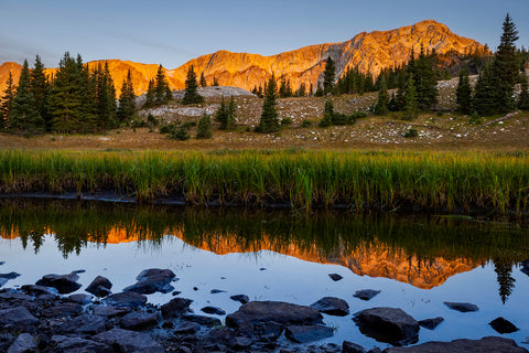 11" x 14" Horizontal Lustre Print  Late summer sunrise along a backcountry pond in the Snowy Range Mountains of the Medicine Bow National Forest  The Snowy Range glows with the sunrise and the beauty is mirrored in the quite water of the pond  Inside a plastic sleeve with cardboard backing for added protection  Ready for a frame of your choice