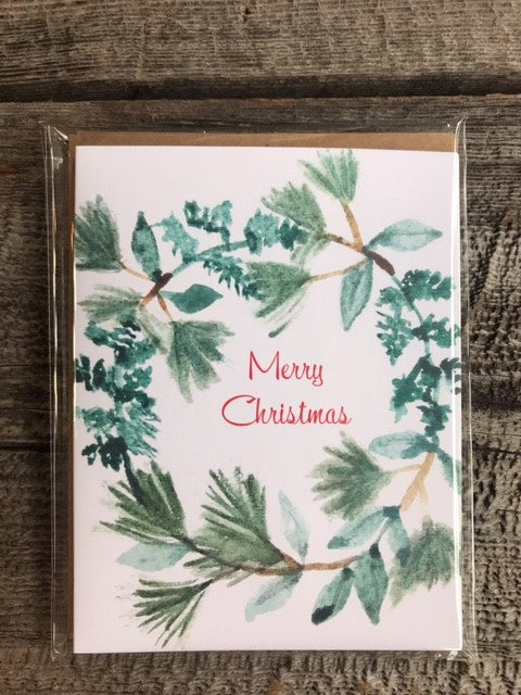 Merry Christmas Wreath Watercolor Greeting Card Package Photographer: Lisa Edwards Green wreath with the words Merry Christmas in middle of wreath  Four pack of cards with brown envelopes  Nice for Christmas cards for all  Blank card  Envelope included   4" wide x 5.5" long 